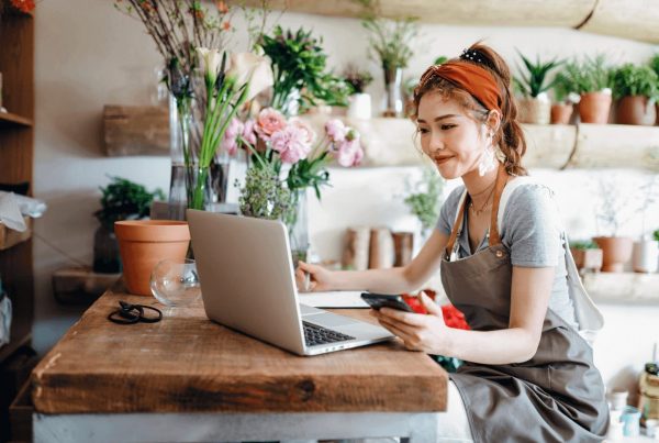 flower shop owner reviewing her interest bearing business checking account