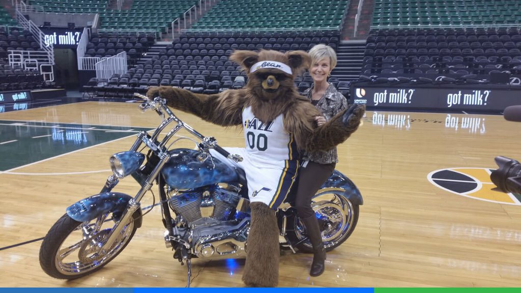 Verena riding with the Jazz Team's mascot.