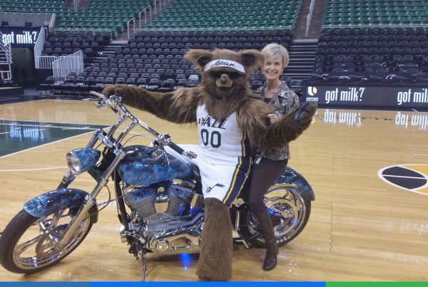 Verena riding with the Jazz Team's mascot.